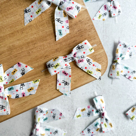 school print pre-tied 4" grosgrain bows with clear twist ties - set of 25