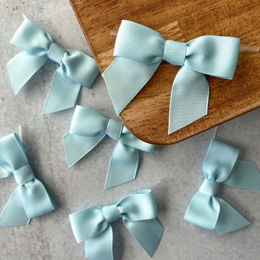 light blue pre-tied 4" grosgrain bows with clear twist ties - set of 25